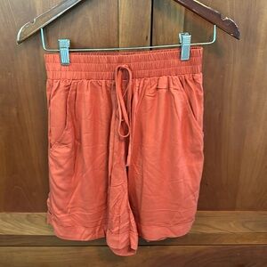 Darling juniors shorts in burnt orange.  Cute bow in front, elastic waist